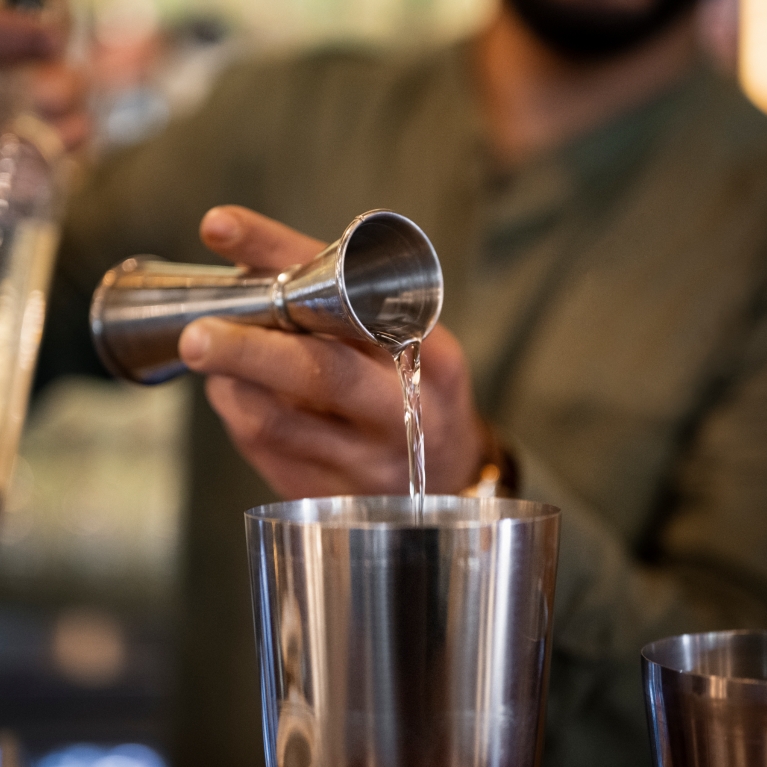 front-view-bartender-making-pina-colada