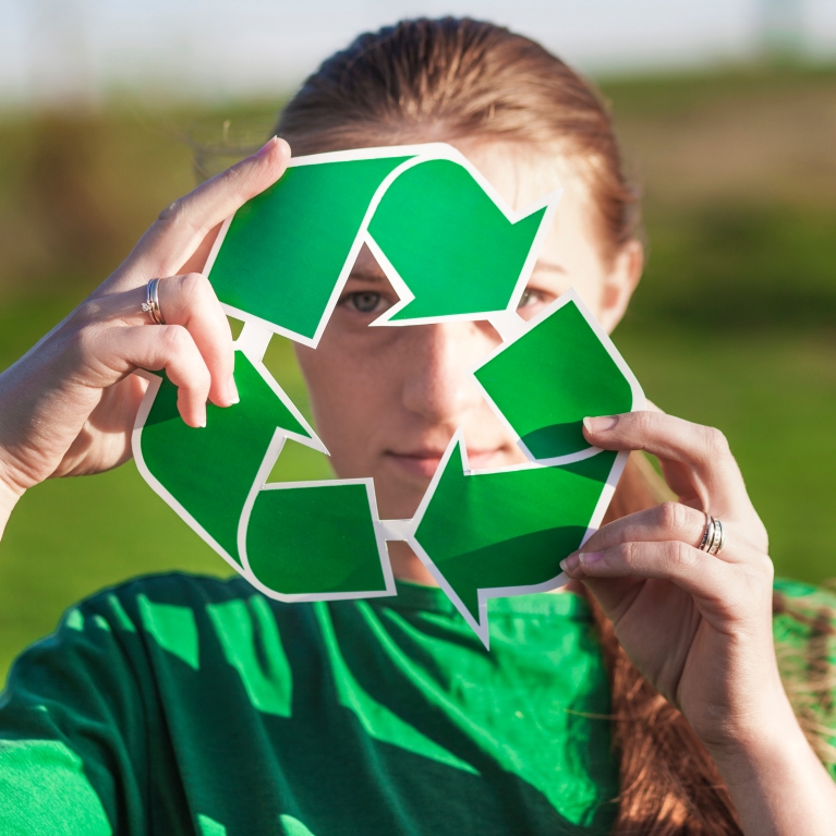 recycle-background-with-woman-holding-recycle-sign