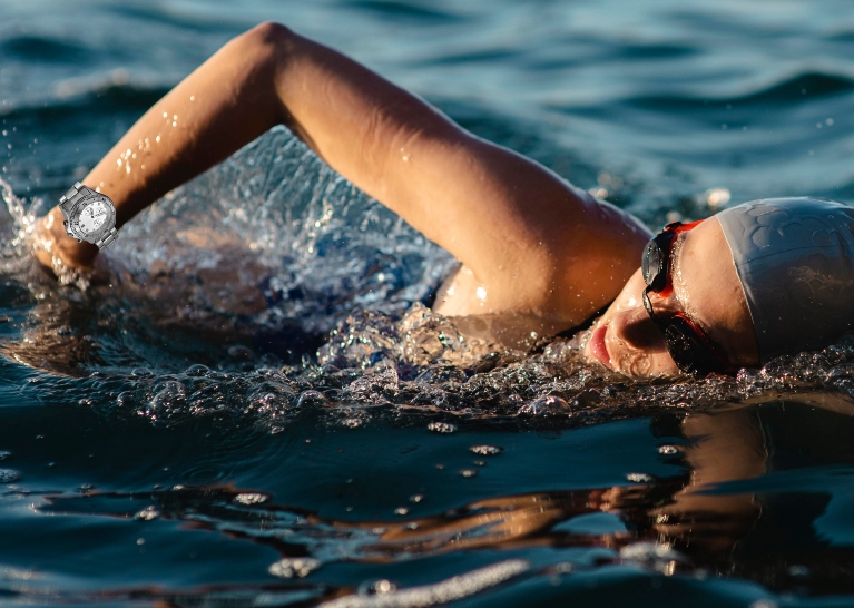 side-view-female-swimmer-with-cap-goggles-swimming-water-1